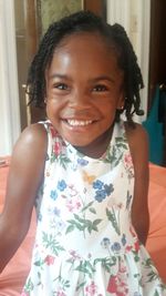 Portrait of smiling girl standing at home