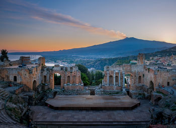 Old buildings against sky during sunset