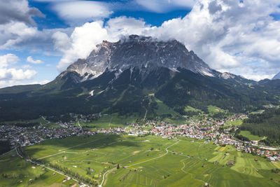 High angle view of townscape and mountains against sky