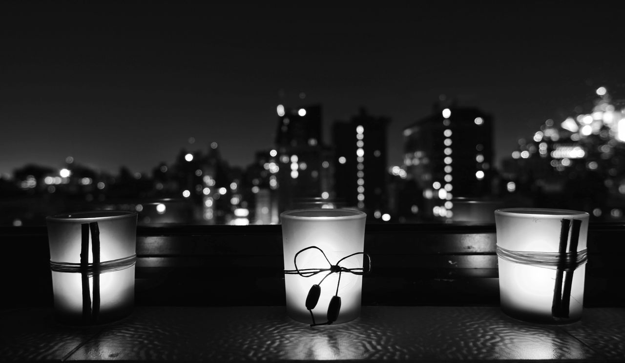 Lights by three. Bokeh Reflection Fuji X-T100 Window Sill Window Nighttime Blurred Background City Illuminated Blackandwhite Bnw_friday_eyeemchallenge Bnw_night_lamp Electric Candles Photography