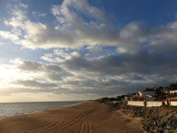 Scenic view of beach against sky in city