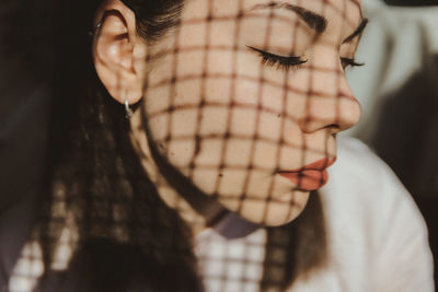 Close-up of woman with eyes closed in sunlight