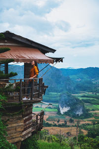 A female traveler in wooden hut with a beautiful mountain and nature view