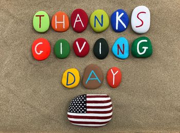 Multi colored text on stones at beach