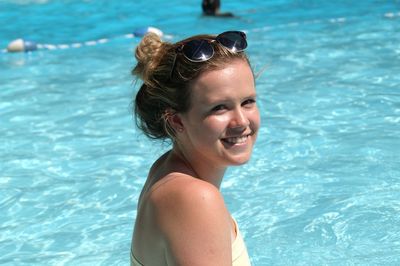 Portrait of teenage girl smiling in pool