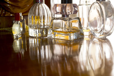 Close-up of perfumes on table