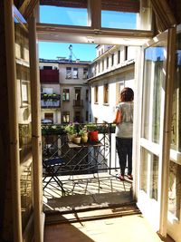 Woman standing by window