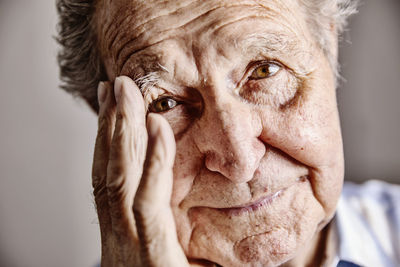 Portrait of senior man with hand on face, close-up