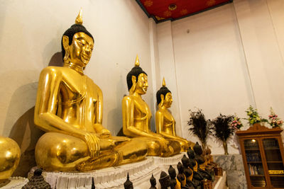 Low angle view of statue against temple building