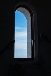 Sea seen through window of abandoned building