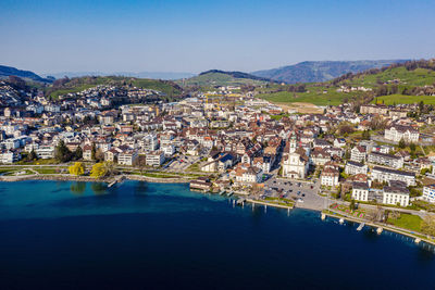 High angle view of townscape by river in city