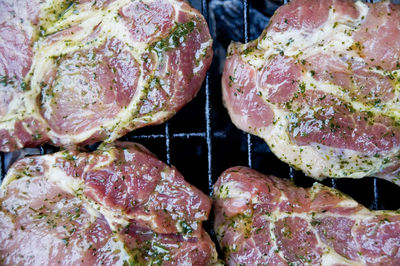 Directly above shot of pork cooking on barbecue grill