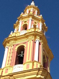 Low angle view of bell tower against sky