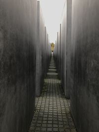 Rear view of people walking on narrow footpath