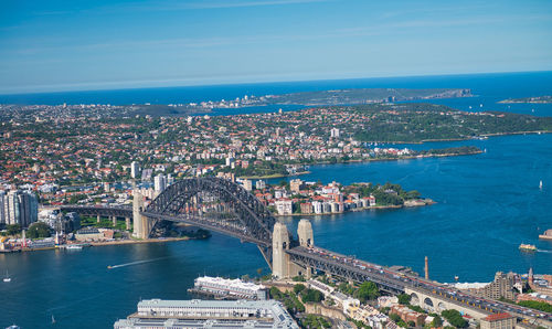 High angle view of buildings by sea against sky