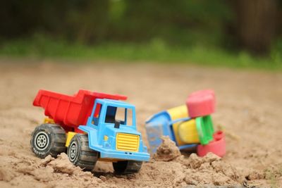 Toy trucks on muddy field