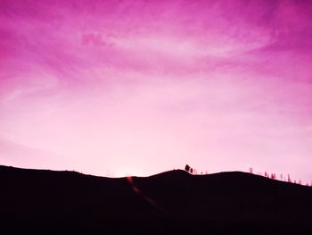 Low angle view of silhouette mountain against sky at sunset