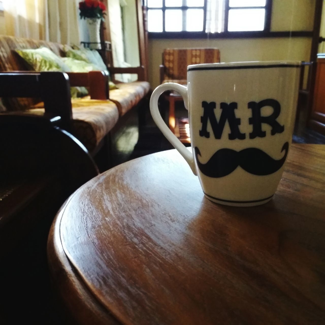 table, drink, indoors, refreshment, food and drink, glass - material, still life, close-up, reflection, drinking glass, no people, coffee cup, chair, window, wood - material, day, transparent, text, restaurant, cafe