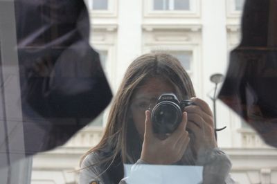 Portrait of woman photographing