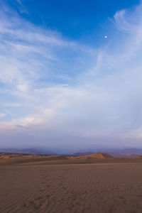 Footprint on rippled sand by sky