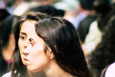 Close-up portrait of young woman looking away