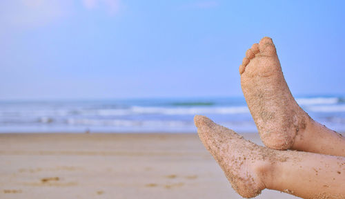 Close-up of sand on beach against sky