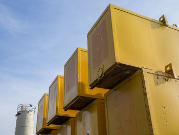 Low angle view of yellow building against sky