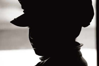 Close-up portrait of silhouette woman against blurred background