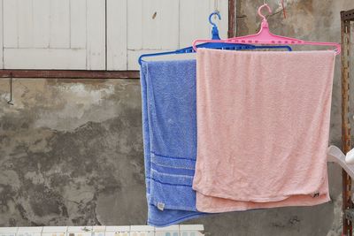 Close-up of clothes drying against wall