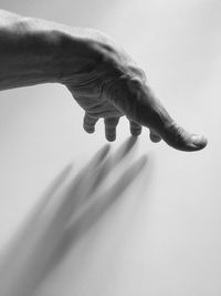 Close-up of hand against white background