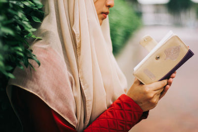 Close-up of woman holding camera