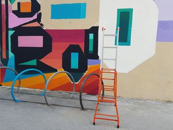 Multi colored chairs against wall in city