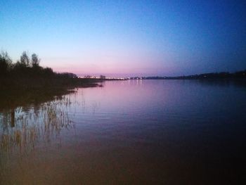 Scenic view of lake against sky at dusk