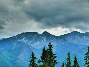 Scenic view of mountains against cloudy sky