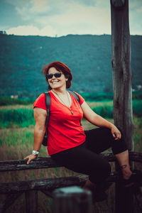 Portrait of smiling young woman sitting outdoors