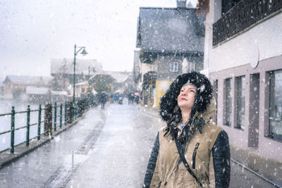 Woman on snow covered city street during winter