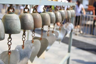Close-up of heart shape bells hanging on street