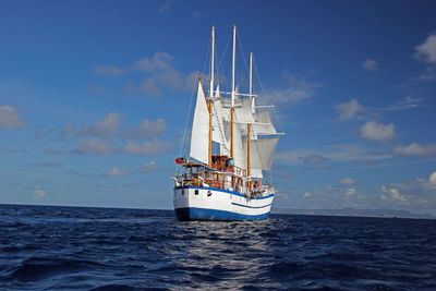 Ship sailing in sea against sky