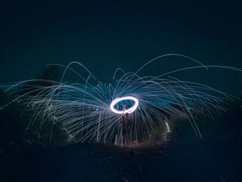 Low angle view of light trails at night