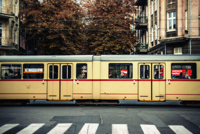 Commuters traveling in cable car in city