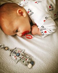 High angle view of baby lying on bed at home