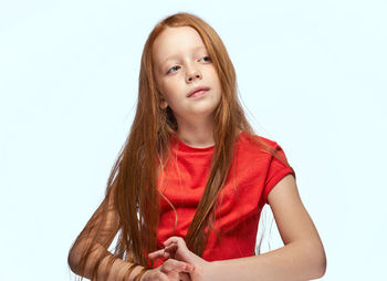 Portrait of young woman against white background