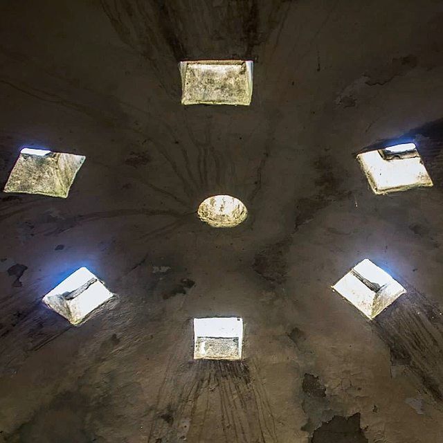 architecture, built structure, low angle view, building exterior, ceiling, indoors, wall - building feature, window, illuminated, lighting equipment, building, abandoned, old, wall, no people, house, electricity, damaged, hanging, day