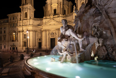 Fountain with statue at night