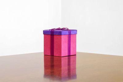 Close-up of red table against white background