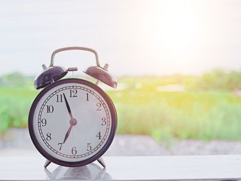 Close-up of clock against sky