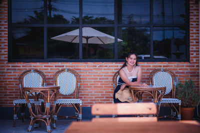 Woman sitting on chair in cafe