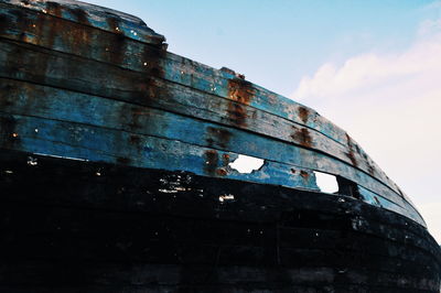 Low angle view of abandoned building against sky