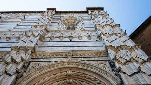Low angle view of ornate building against sky