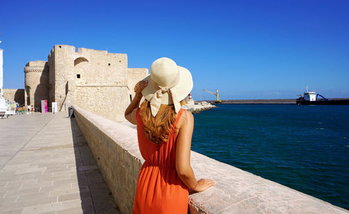Vacation in puglia, italy. attractive woman visiting monopoli town in apulia, italy.